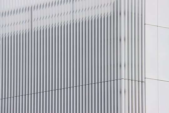 White outdoor wall slat cladding on a commercial building