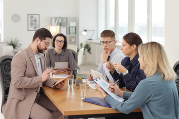 Obraz premium Coworkers working together at wooden table in office