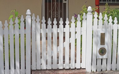 Front gate of a white picket fence