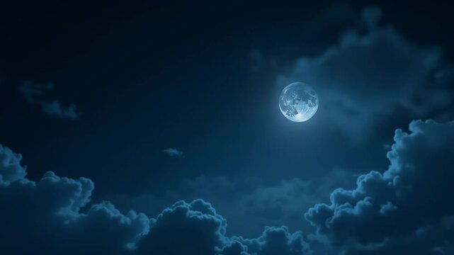 Bright full moon shining through clouds in a dark night sky  