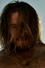 Long-haired bearded man posing on the beach of Turkey.
