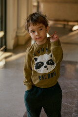 Little caucasian boy is playing in the hotel lobby by himself.