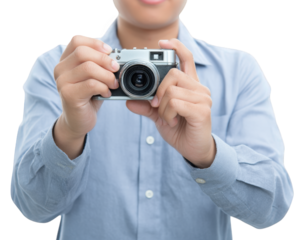 Person holding vintage camera, ready to take photograph, wearing light blue shirt. expression conveys excitement and anticipation for capturing moment