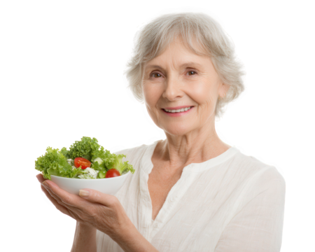 Cheerful elderly woman holds bowl of fresh salad, showcasing vibrant greens and cherry tomatoes. Her warm smile reflects healthy lifestyle and joy in sharing nutritious food