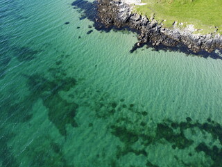 Port Charlotte is a town on the west coast of Islay, Scotland. Whisky distilleries and hotels dot the area, with scenic shorelines and historic charm. © Optimistic Fish