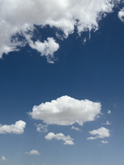 Obraz premium Beautiful white clouds in a blue sky background. Cotton clouds in blue sky. Natural view of clouds. Meteorology and environment concept background. Cumulus clouds background. Cotton cloud in summer. 