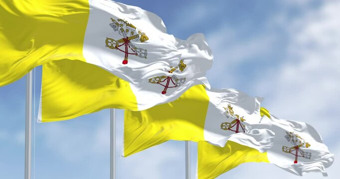 Flags of Vatican City waving in the wind on a clear day