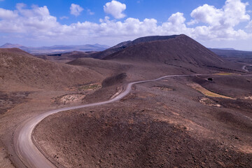 Dirt road across barren volcanic land in Fuerteventura