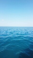 Obraz premium Vast, calm ocean surface extending to the horizon, undisturbed by waves, reflecting a clear sky Perfect for backgrounds or travel imagery , surface, serenity