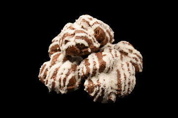 Profiteroles with coconut cream on a black background.