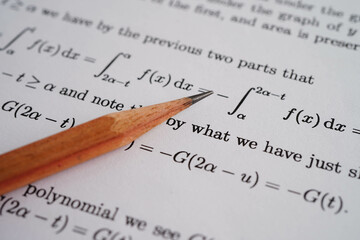 Pencil on mathematic formula exercise test paper in education school.