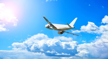 Flying airplane, travel background with airplane flying in the clear blue sky, summer air travel...