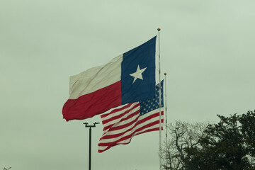 A Texas flag and American flag side by side.