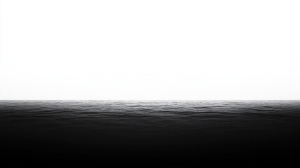 A serene black and white seascape with a calm horizon.