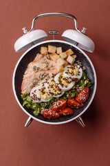 Caesar salad with chicken, croutons, tomatoes and eggs with seeds and grains