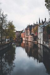 canal view at dusk in the city of brugge in belgium, with reflections on the water