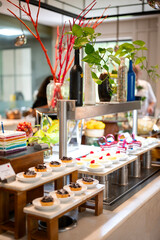 Assorted dessert counter at a hotel buffet featuring cakes, pastries, and sweets beautifully arranged under warm lighting for a luxurious dining experience.