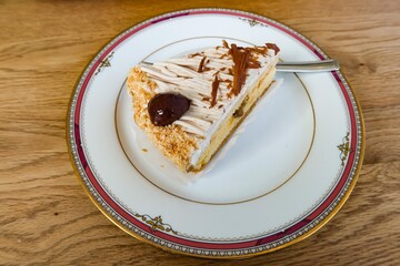 close up of chestnut cream sponge cake on a old traditional plate with copy space
