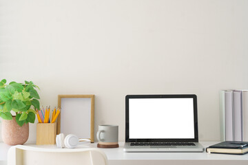 Modern workspace with blank laptop display ready for mockup use, surrounded by practical and aesthetic elements.