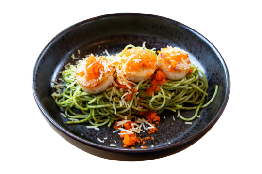 Spaghetti with shrimp and orange crab roe with seafood salad served on black plate isolated on cutout PNG or transparent background. Green tea spaghetti noodles beautiful and delicious Italian food.