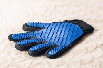 Glove with rubber spikes for combing out shedding hair from pets
