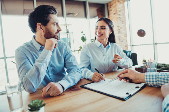 Team discussing business strategy during a collaborative meeting in a modern office setting, planning ideas and solutions