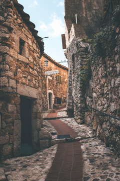 street view in the old town of eza village in cote d'azul, france, on a quiet sunny day. detail of narrow street