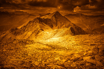 Fantasy orange effect color of alpine peaks panorama with a dramatic sky, Vallelunga, Alto Adige - Sudtirol, Italy. Popular mountain for climbers. Abstract image