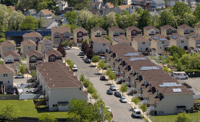 Row of identical stand alone houses on a suburban street in Staten Island New York City.