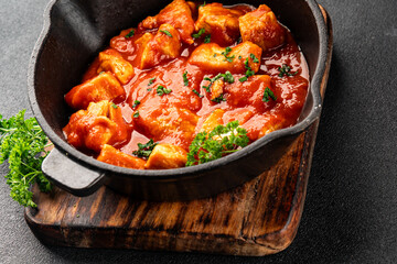 Butter chicken curry tomato sauce poultry meat dish turkey fresh tasty gourmet food background on the table rustic food top view copy space