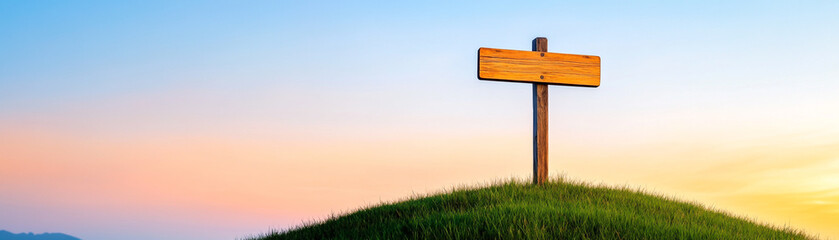 A serene landscape featuring a signpost on a grassy hill under a colorful sunset.