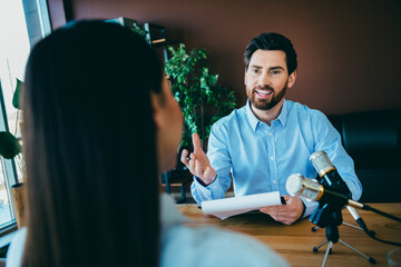 Professional interviewer and candidate discussing business ideas in a modern office setting with...