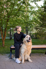 girl hugs her favorite dog breed golden retriever