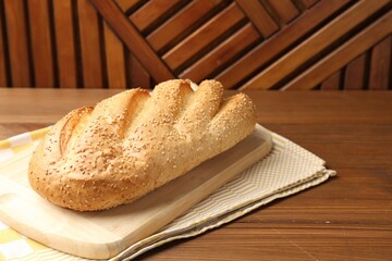 One bread loaf on wooden table Space for text