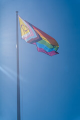 A Pride Flag against Clear Blue Sky