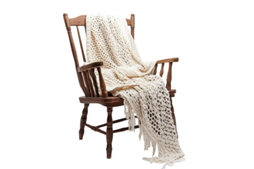A comforting scene of a handmade knitted blanket draped gently over a vintage wooden rocking on transparent background