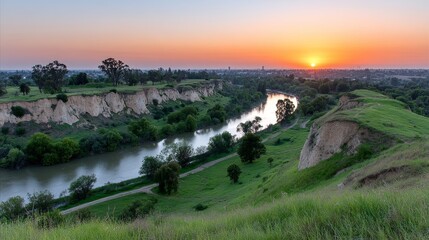 Obraz premium Scenic River Valley Sunset Landscape - Serene sunrise over a meandering river, nestled within green hills. Symbolising tranquility, nature's beauty, peace, renewal, and escape