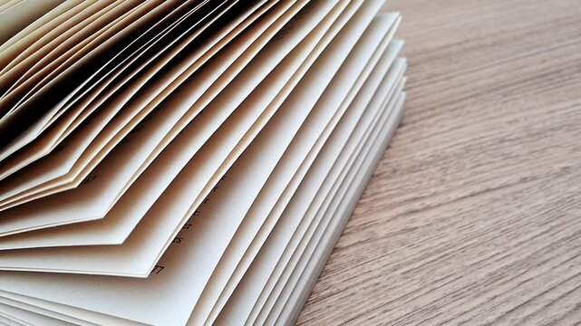 Book papers with abundance pages on wood table background 