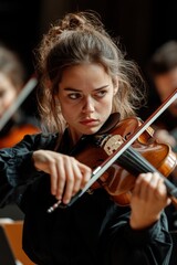 Fototapeta premium Young violinist performs in an orchestra during a concert in a historic venue