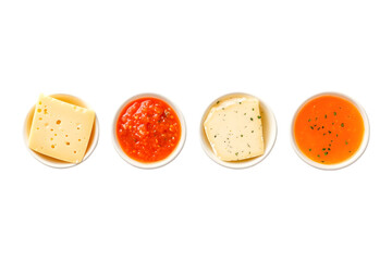Overhead view of four small bowls with cheese and sauces.  Perfect for food blogs, menus, or culinary websites.