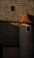 A close-up view highlights a round, turret-like architectural feature on a historical building. The...
