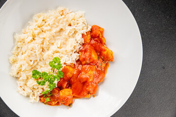 Rice butter chicken curry chicken tikka masala spicy meat in a bowl on the table fresh tasty gourmet food background on rustic food top view copy space