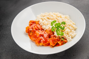 Rice butter chicken curry chicken tikka masala spicy meat in a bowl on the table fresh tasty gourmet food background on rustic food top view copy space