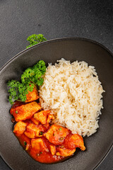 Rice butter chicken curry chicken tikka masala spicy meat in a bowl on the table fresh tasty gourmet food background on rustic food top view copy space