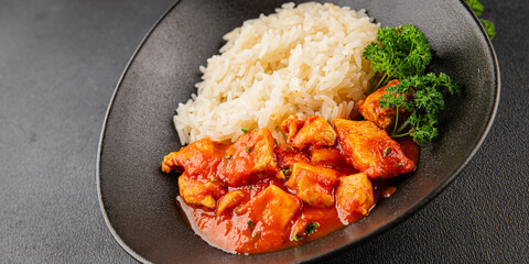 Rice butter chicken curry chicken tikka masala spicy meat in a bowl on the table fresh tasty gourmet food background on rustic food top view copy space