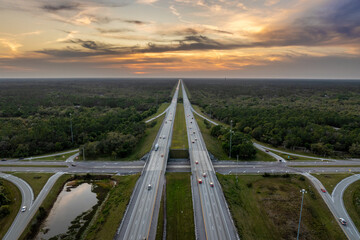 Freeway overpass junction in Florida with fast moving traffic cars and trucks in American rural...