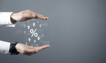 Fototapeta premium Human with a percent symbol and growing arrows. Business