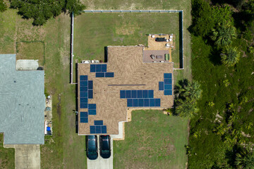 Aerial view of American home roof with blue solar photovoltaic panels for producing clean ecological electric energy. Renewable electricity with zero emission concept