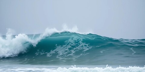 Naklejka premium Ocean wave crashing, frothy whitecap, grey sky, empty space, abstract, stock photo