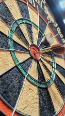 Dartboard with Dart in Bullseye, Metal Wire Grid, Tan and Black Sections, Red Center